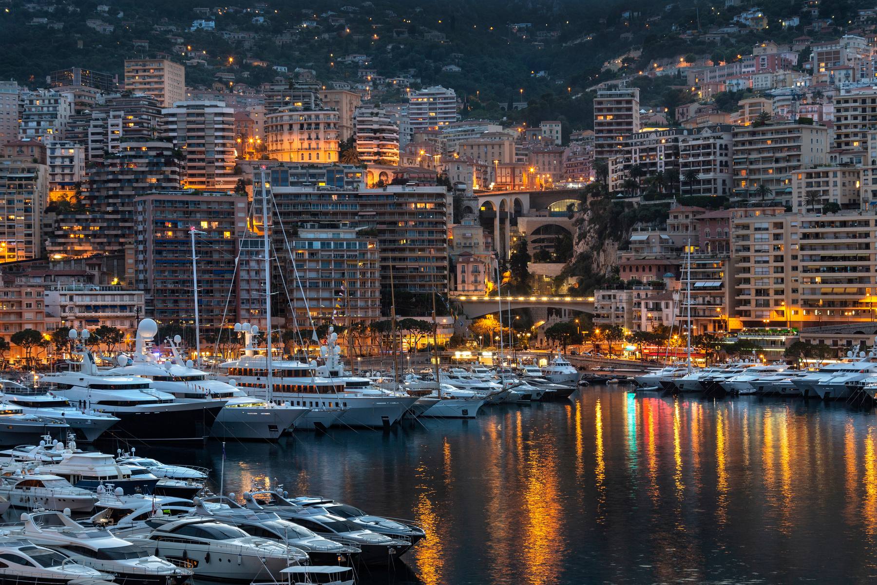 Port Hercule, Monaco at dusk, the quays lined with berthed yachts